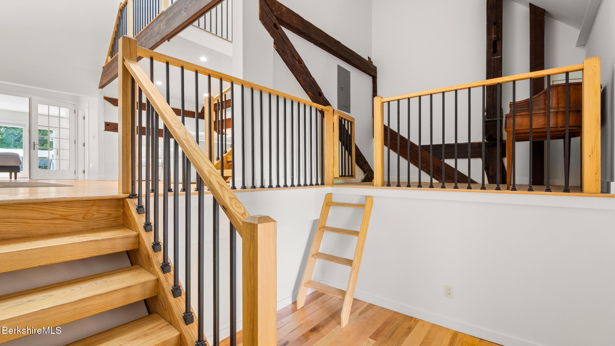 160 High Street Lee, MA 01238 - Photo 56 of 68 a view of staircase with lots of frames on wall and a large window