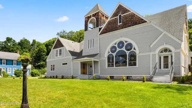 a view of a backyard with large trees