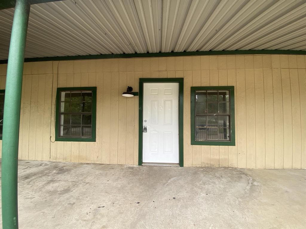 Entrance to property featuring a porch