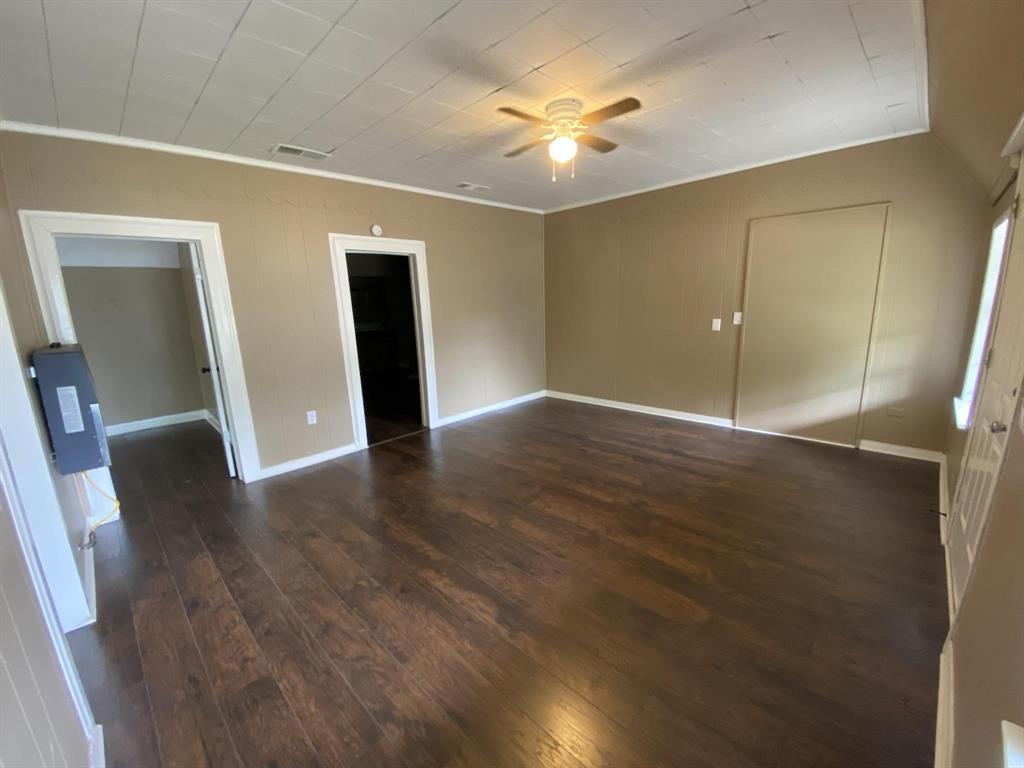 625 York Street, Unit B Athens, TX 75751 - Photo 3 of 15 Unfurnished bedroom with dark wood-type flooring, ceiling fan, and a closet