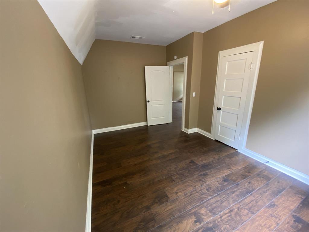 625 York Street, Unit B Athens, TX 75751 - Photo 8 of 15 Unfurnished bedroom with dark wood-style flooring and baseboards