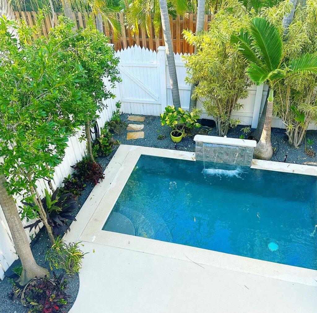 809 Washington Street, Unit 102 Key West, FL 33040 - Photo 1 of 33 a view of a backyard with plants and a fountain
