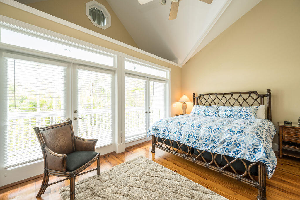 809 Washington Street, Unit 102 Key West, FL 33040 - Photo 13 of 33 a bedroom with a bed and chair