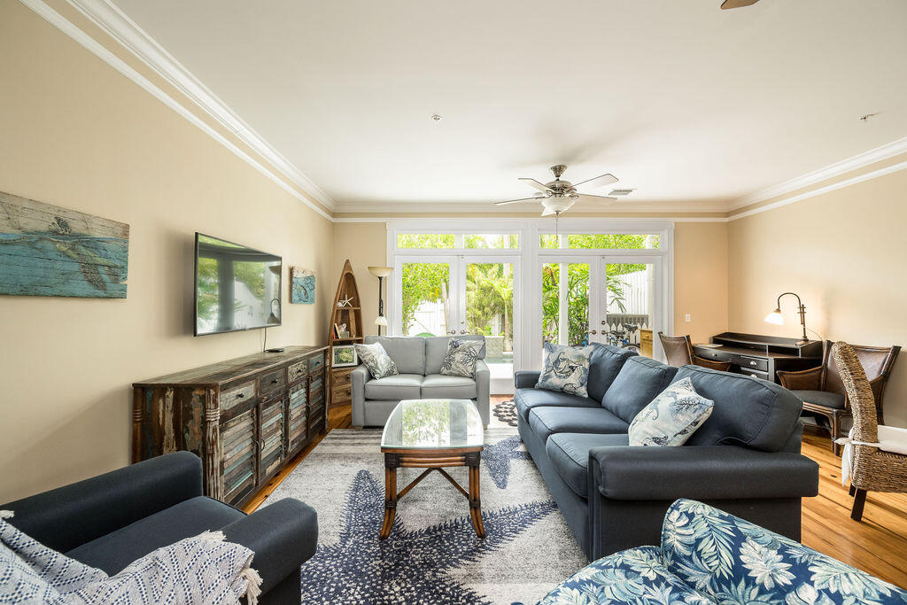 809 Washington Street, Unit 102 Key West, FL 33040 - Photo 2 of 33 a living room with furniture and a large window