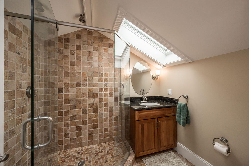 809 Washington Street, Unit 102 Key West, FL 33040 - Photo 28 of 33 a bathroom with a granite countertop sink a stove and shower