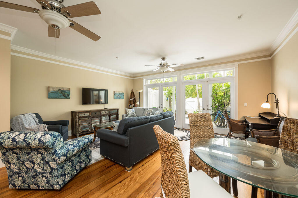 809 Washington Street, Unit 102 Key West, FL 33040 - Photo 3 of 33 a living room with furniture and a flat screen tv
