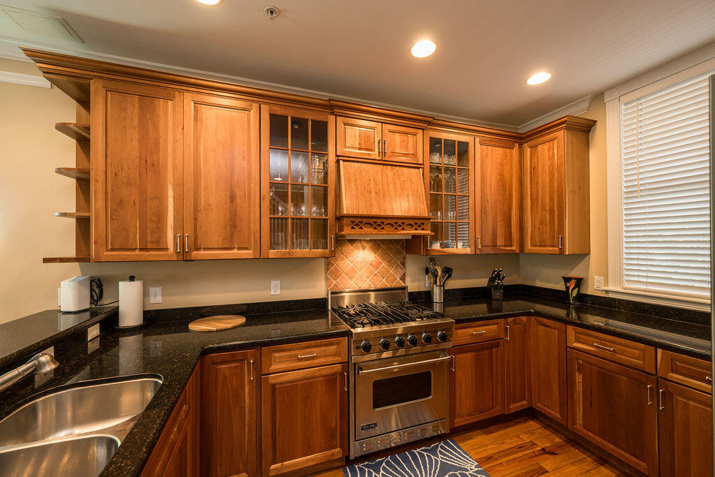 809 Washington Street, Unit 102 Key West, FL 33040 - Photo 4 of 33 a kitchen with a sink stove top oven and cabinets