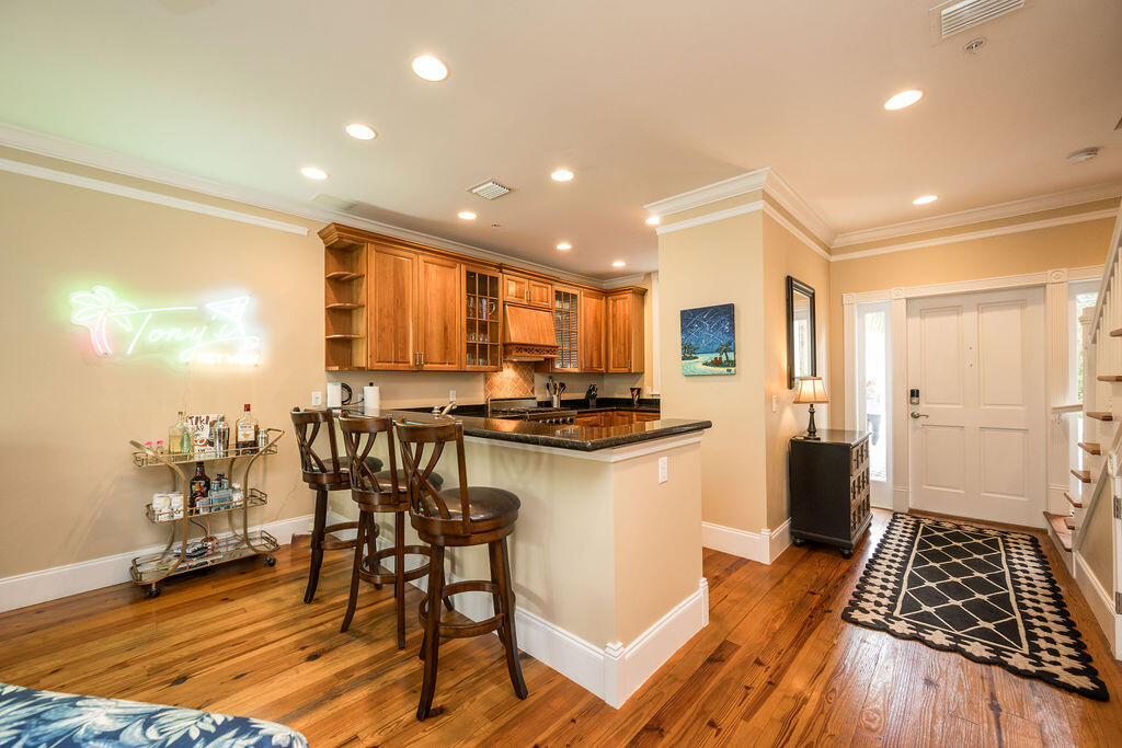809 Washington Street, Unit 102 Key West, FL 33040 - Photo 5 of 33 a kitchen with a table and chairs in it