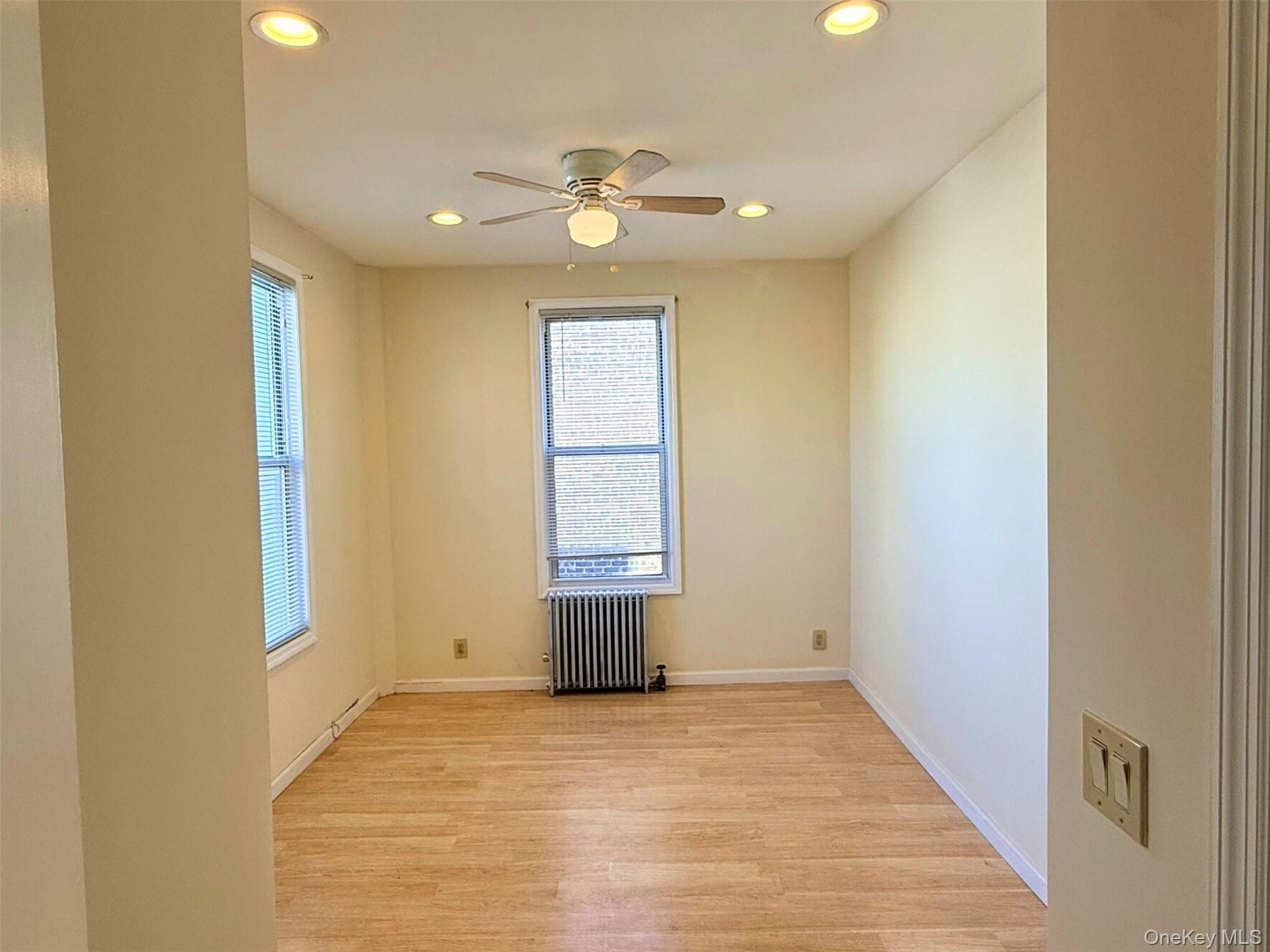 52-05 35th Street, Unit 2 Queens, NY 11101 - Photo 12 of 32 a view of empty room with wooden floor and fan