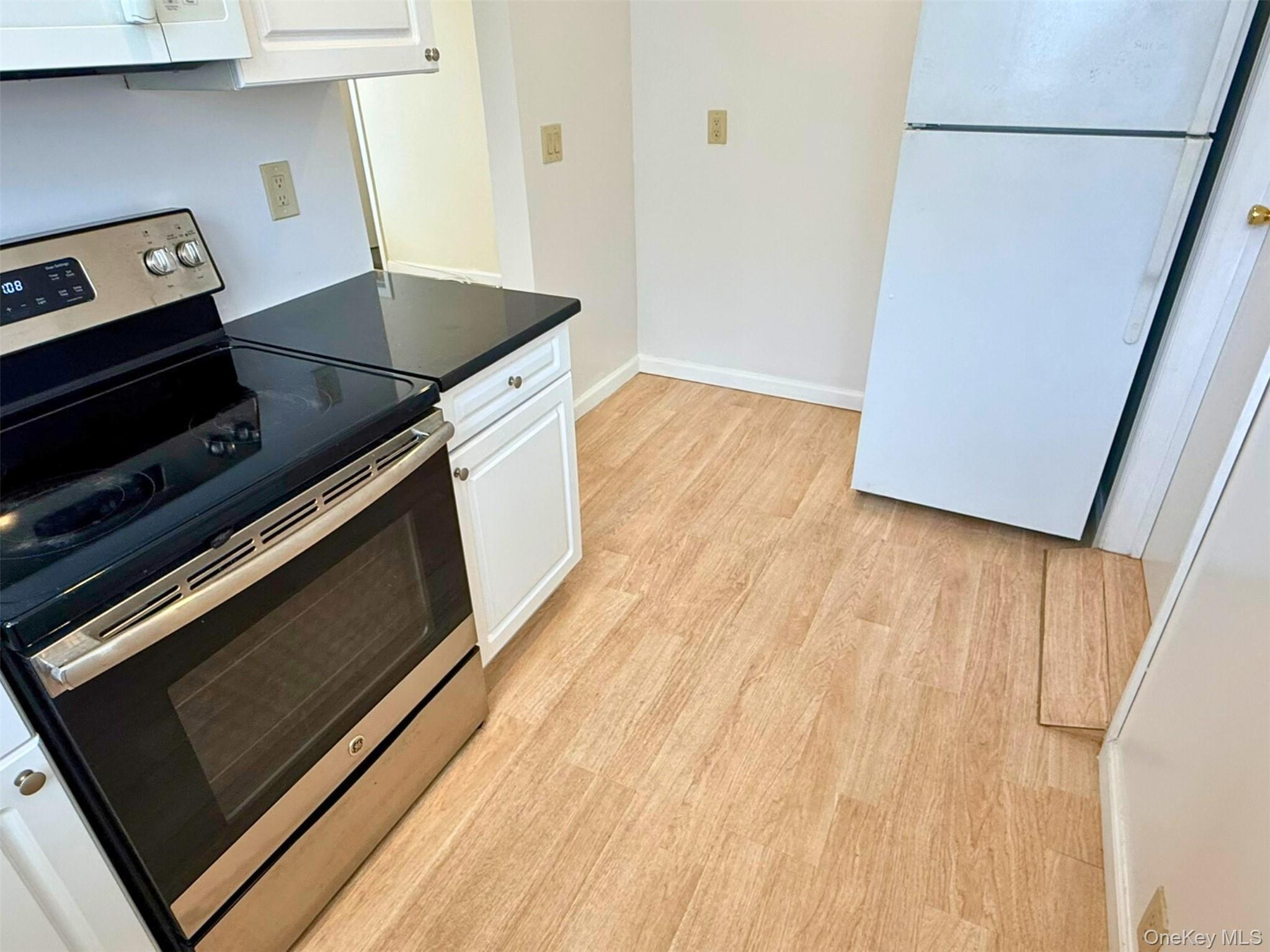 52-05 35th Street, Unit 2 Queens, NY 11101 - Photo 2 of 32 a kitchen with wooden floors and a stove