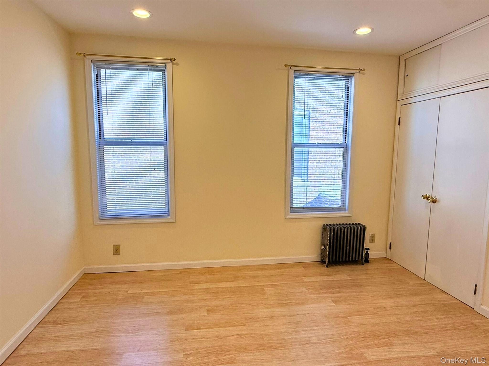 52-05 35th Street, Unit 2 Queens, NY 11101 - Photo 23 of 32 a view of an empty room with wooden floor and a window
