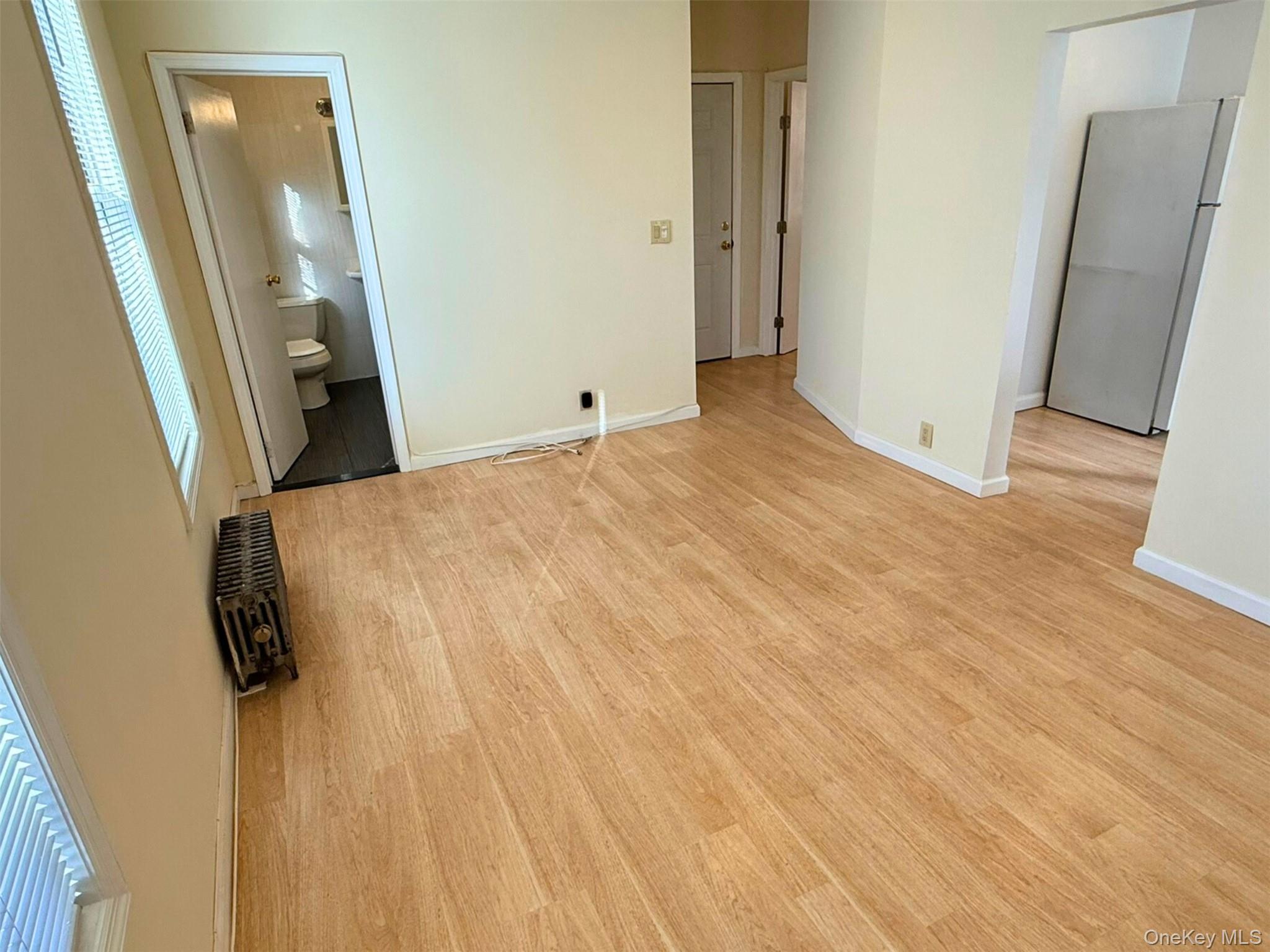 52-05 35th Street, Unit 2 Queens, NY 11101 - Photo 4 of 32 a view of a hallway with wooden floor and staircase