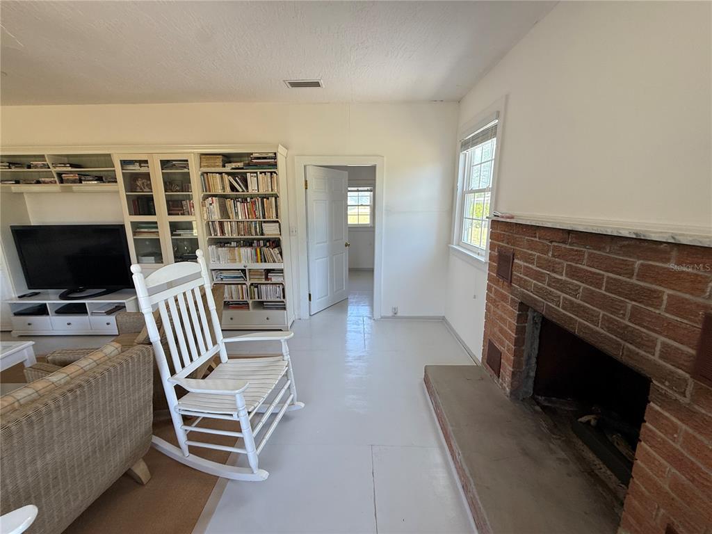 7390 South Mc Alpin Road McAlpin, FL 32062 - Photo 6 of 53 a living room with furniture a flat screen tv and a fireplace