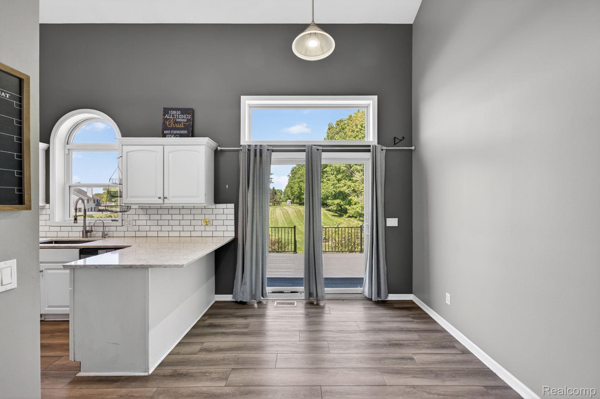 9055 Hegel Road Grand Blanc, MI 48439 - Photo 21 of 62 Open concept kitchen and dining area with wood-finish flooring