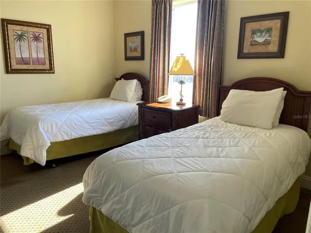 a bathroom with a granite countertop bathtub shower sink vanity and toilet