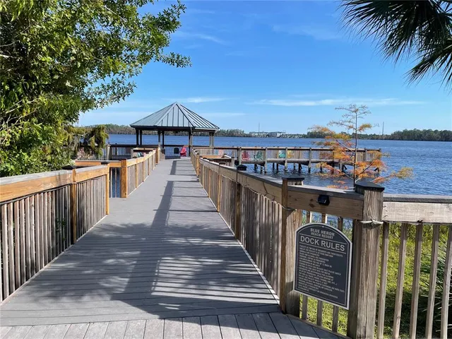 a view of a roof deck with chair and wooden floor