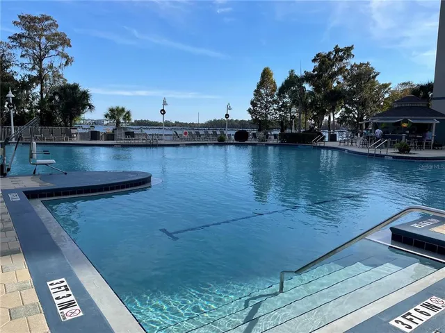 a view of swimming pool with outdoor seating and plants