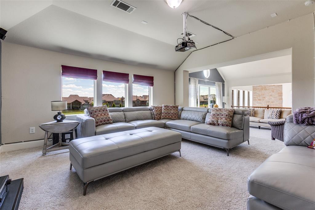 3620 Acropolis Way Plano, TX 75074 - Photo 24 of 25 a living room with furniture ceiling fan and a rug
