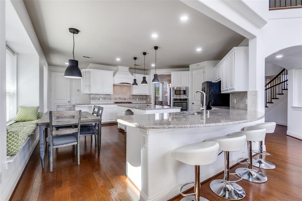 3620 Acropolis Way Plano, TX 75074 - Photo 10 of 25 a large kitchen with a table and chairs