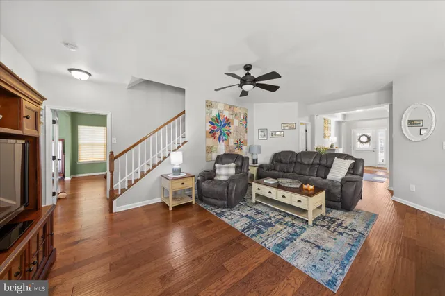 a kitchen with granite countertop white cabinets and stainless steel appliances