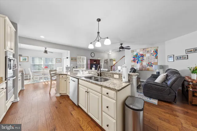 a living room with furniture and kitchen view
