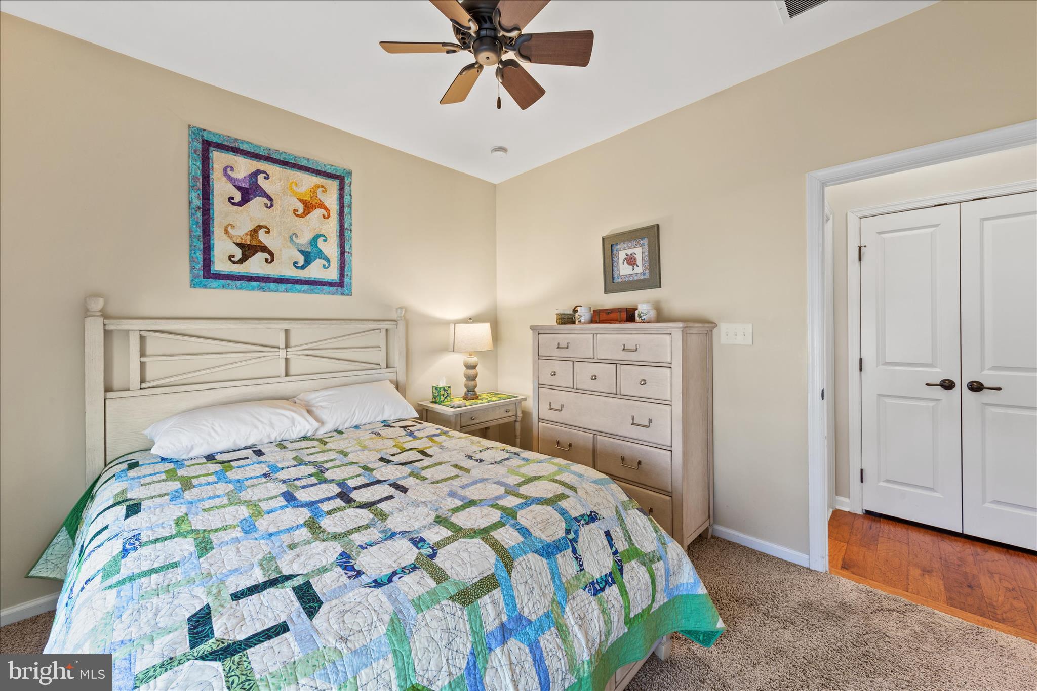 21329 North Acorn Way Lewes, DE 19958 - Photo 24 of 68 a bedroom with a bed and a chandelier