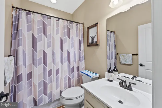 a spacious bathroom with a granite countertop sink and a mirror