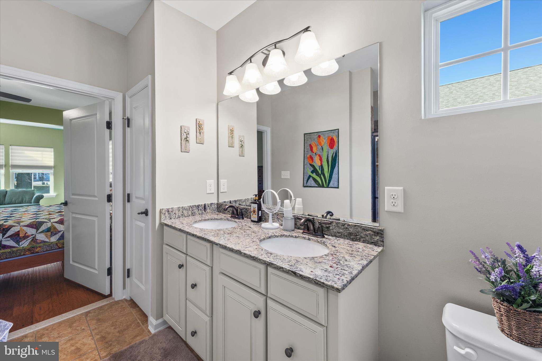 21329 North Acorn Way Lewes, DE 19958 - Photo 35 of 68 a bathroom with a granite countertop sink and a mirror