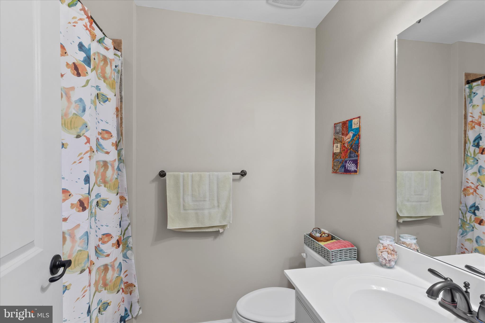 21329 North Acorn Way Lewes, DE 19958 - Photo 43 of 68 a bathroom with a sink toilet and a shower curtain