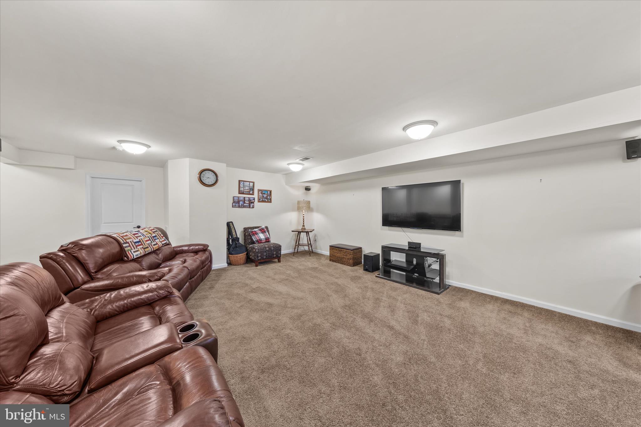 21329 North Acorn Way Lewes, DE 19958 - Photo 54 of 68 a living room with furniture and a flat screen tv