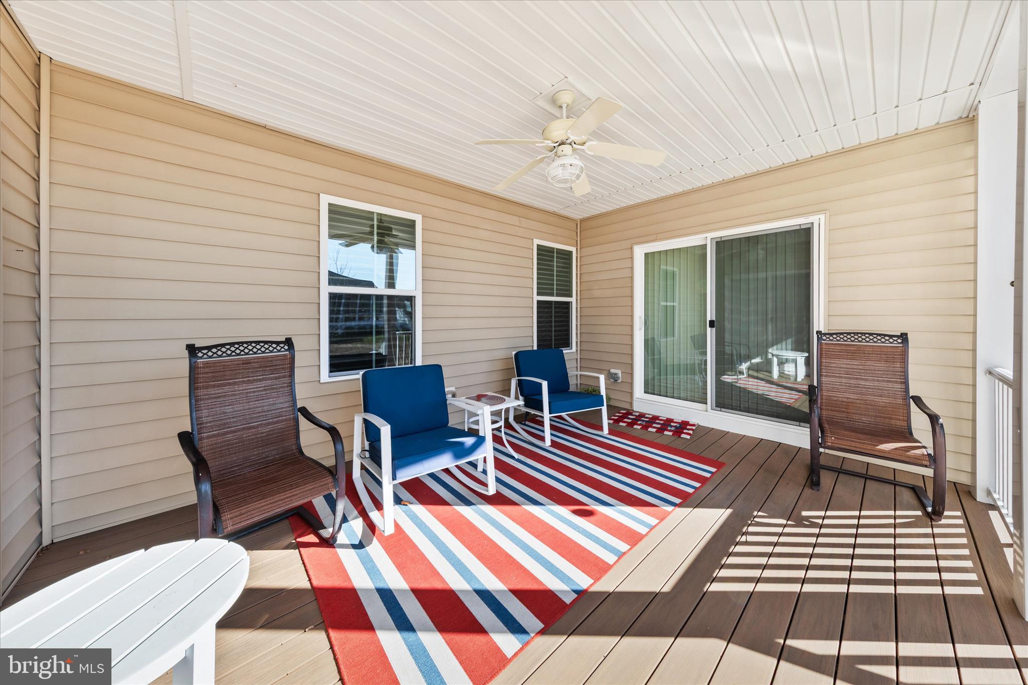21329 North Acorn Way Lewes, DE 19958 - Photo 62 of 68 a backyard of a house with wooden floor outdoor seating and view living room