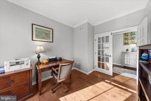 a living room with furniture kitchen view and a large window