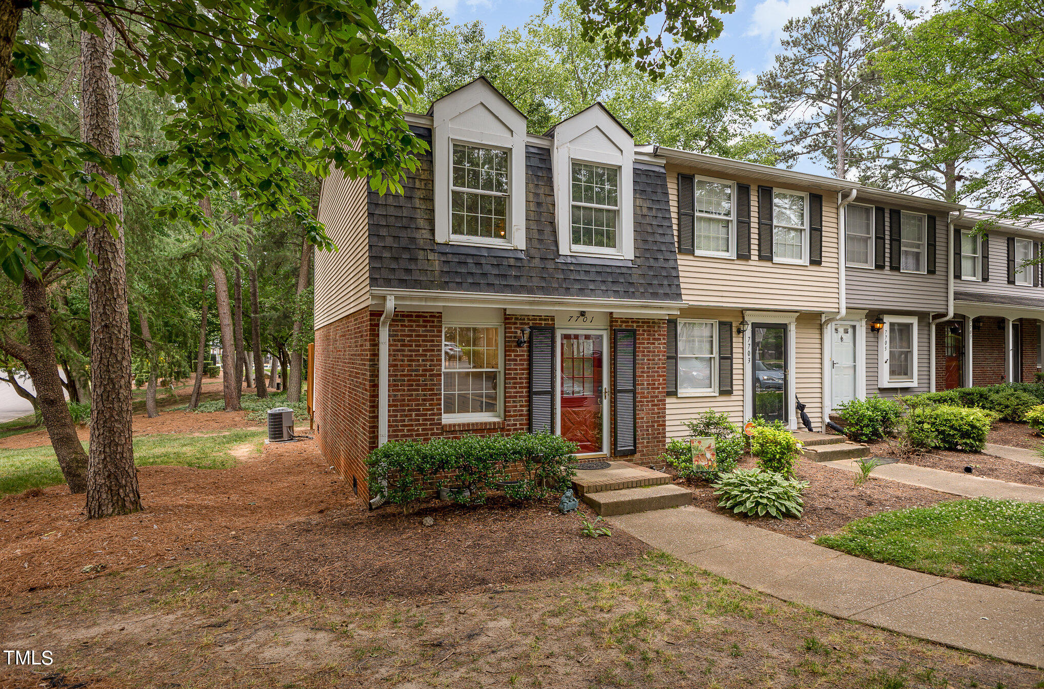 7701 Crown Crest Court Raleigh, NC 27615 - Photo 2 of 18 a front view of a house with garden and trees