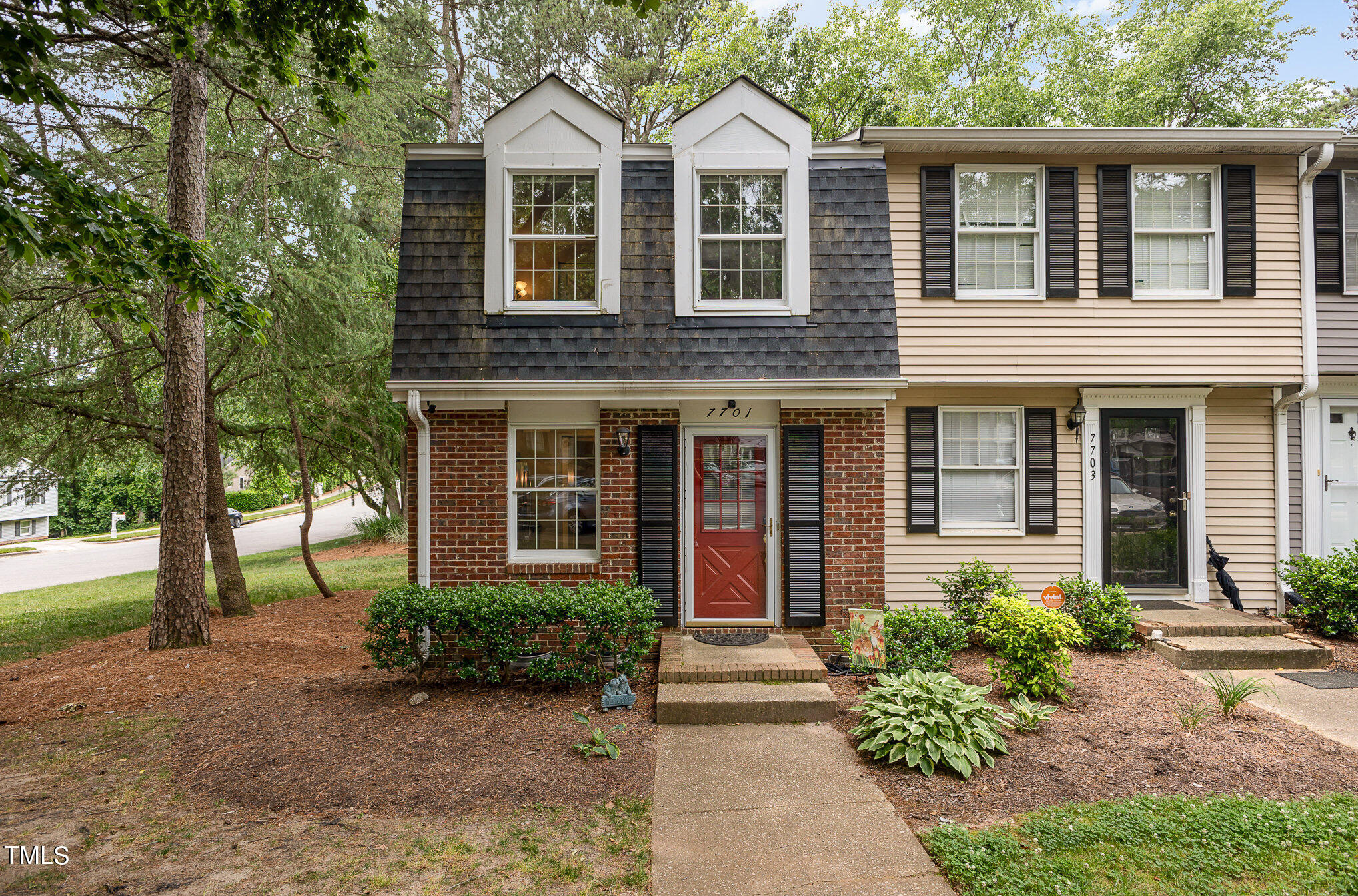 7701 Crown Crest Court Raleigh, NC 27615 - Photo 3 of 18 front view of a brick house with a yard