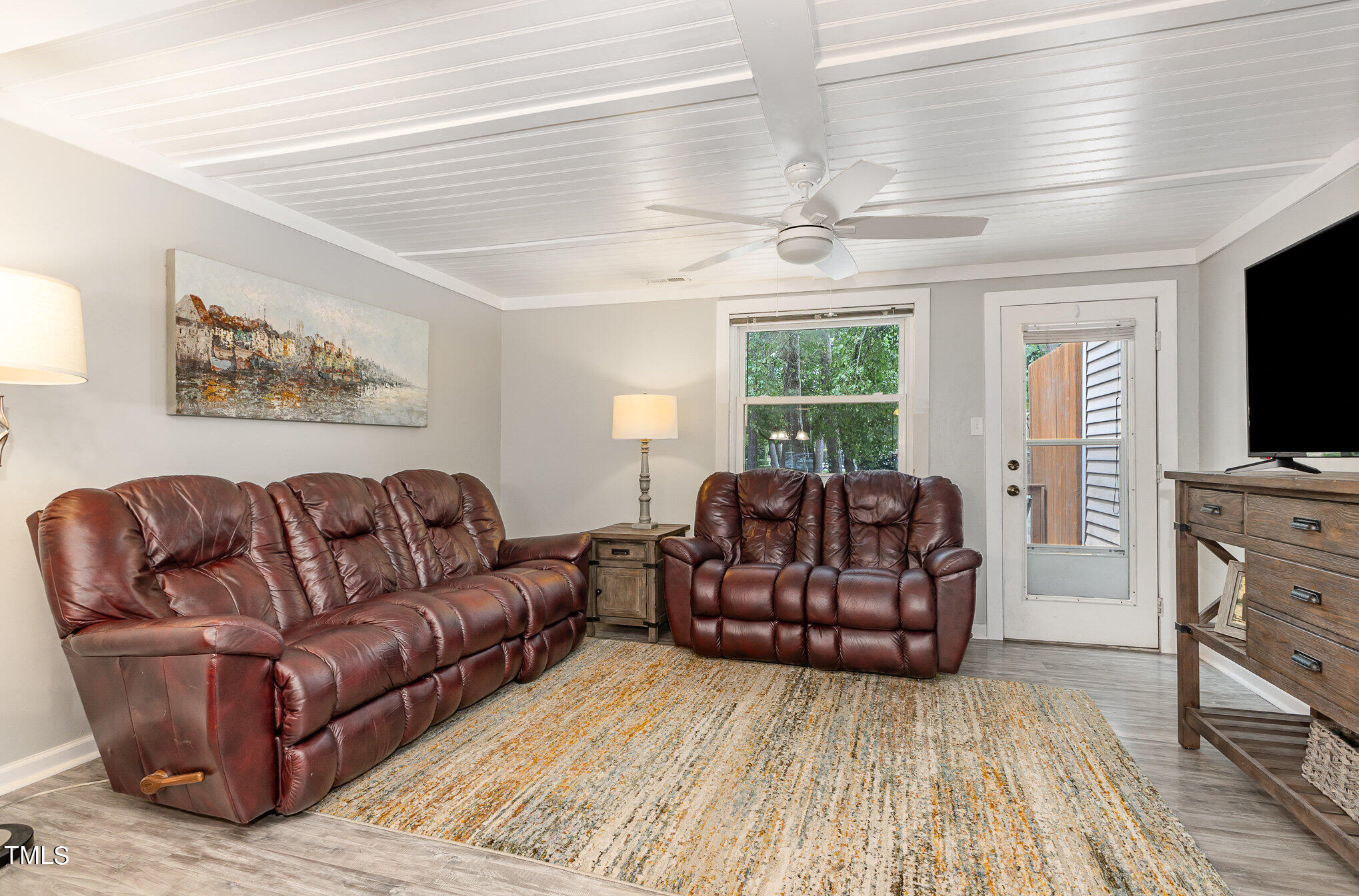 7701 Crown Crest Court Raleigh, NC 27615 - Photo 6 of 18 a living room with furniture and a flat screen tv