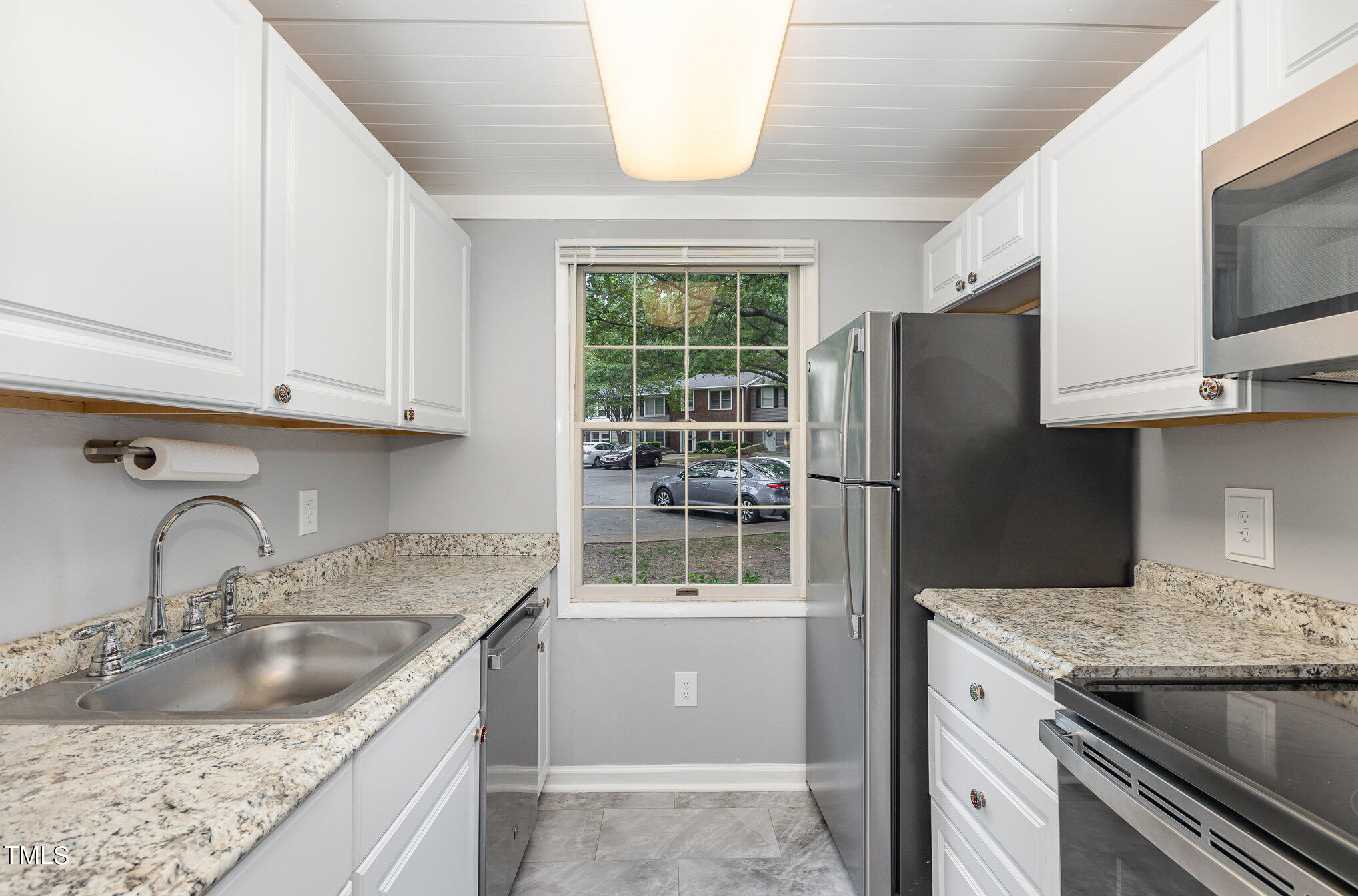 7701 Crown Crest Court Raleigh, NC 27615 - Photo 8 of 18 a kitchen with granite countertop a sink stainless steel appliances and cabinets