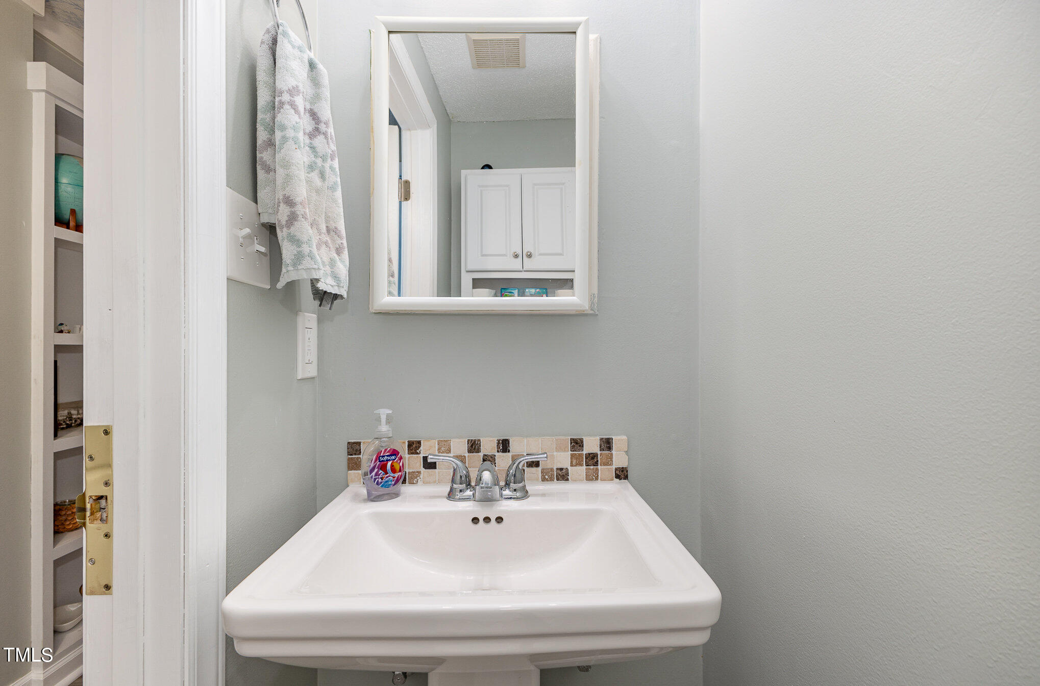 7701 Crown Crest Court Raleigh, NC 27615 - Photo 10 of 18 a bathroom with a sink and a mirror