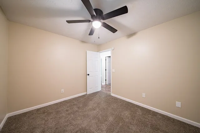 an empty room with a ceiling fan and a ceiling fan