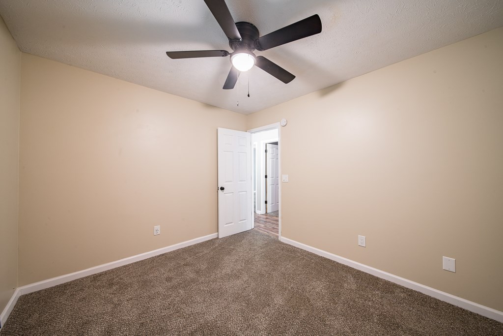 39 West Scotch Drive Fortson, GA 31808 - Photo 14 of 34 an empty room with a ceiling fan and a ceiling fan