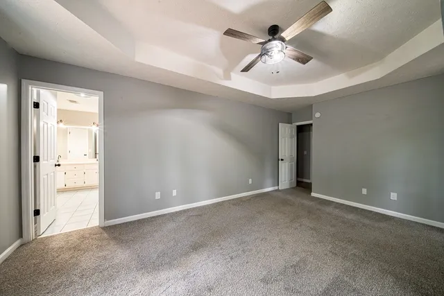 wooden floor in an empty room and a ceiling fan