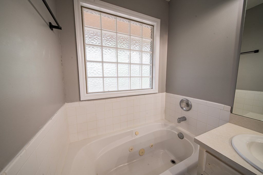 39 West Scotch Drive Fortson, GA 31808 - Photo 23 of 34 a white bath tub sitting next to a window