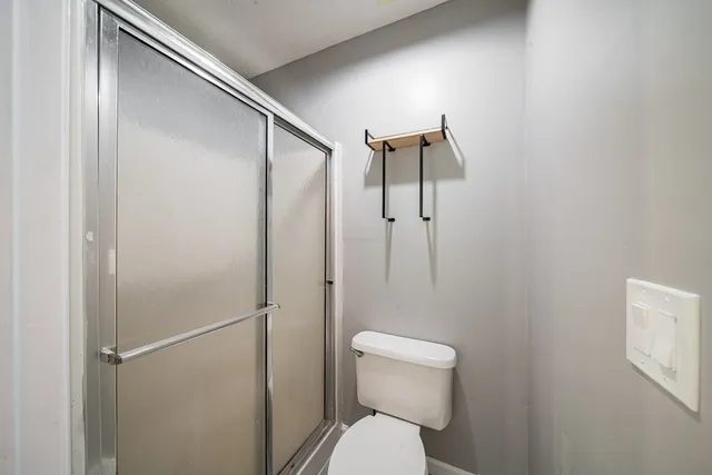 a bathroom with a toilet and a shower