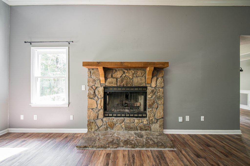 39 West Scotch Drive Fortson, GA 31808 - Photo 4 of 34 a view of an empty room with wooden floor fireplace and a window