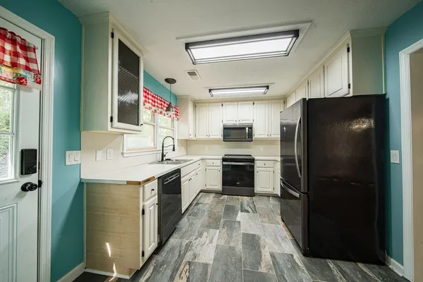 a kitchen with cabinets and stainless steel appliances