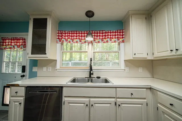 a kitchen with a sink cabinets and window