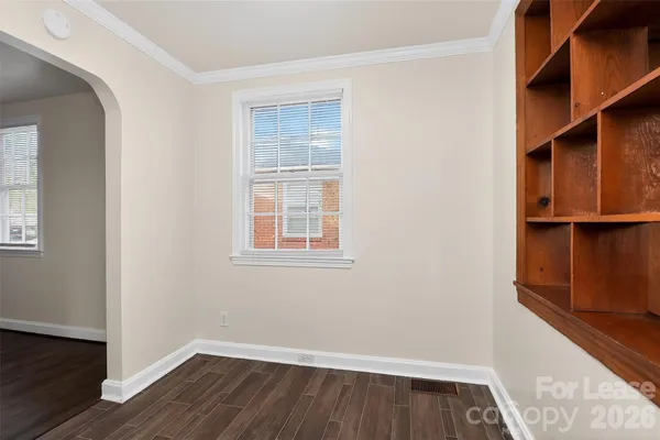 an empty room with wooden floor and a window