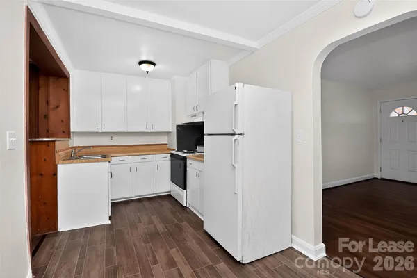 a kitchen with white cabinets and white appliances