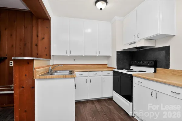 a kitchen with a sink and a refrigerator