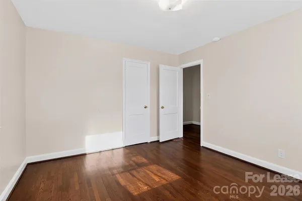 an empty room with wooden floor