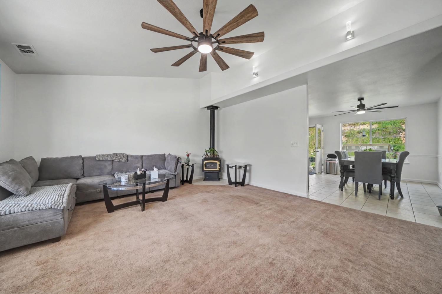 7761 Jenny Lind Road Valley Springs, CA 95252 - Photo 5 of 35 a living room with furniture and a chandelier